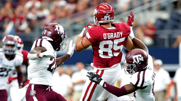 Arkansas Razorbacks tight end Cheyenne O'Grady (85) catches a pass against Texas A&M Aggies defensive back Demani Richardson (26) and defensive back Keldrick Carper (14) in the second quarter at AT&T Stadium.